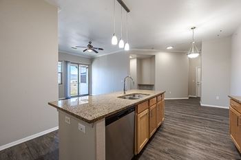 A kitchen with a granite countertop and stainless steel appliances at Vistas at Jackson Creek, Monument, CO